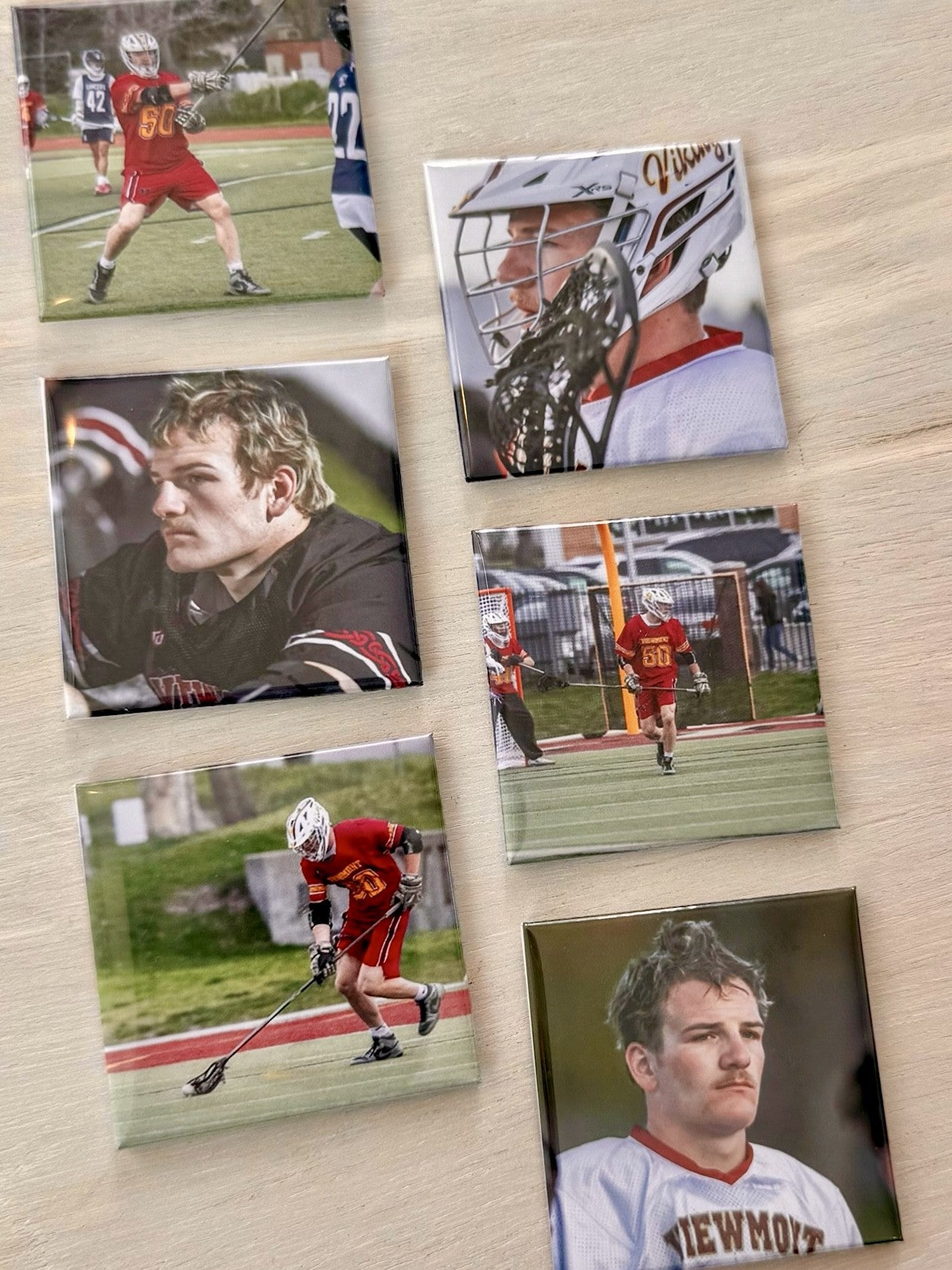 Collage of sports-themed photo magnets on a wooden surface.