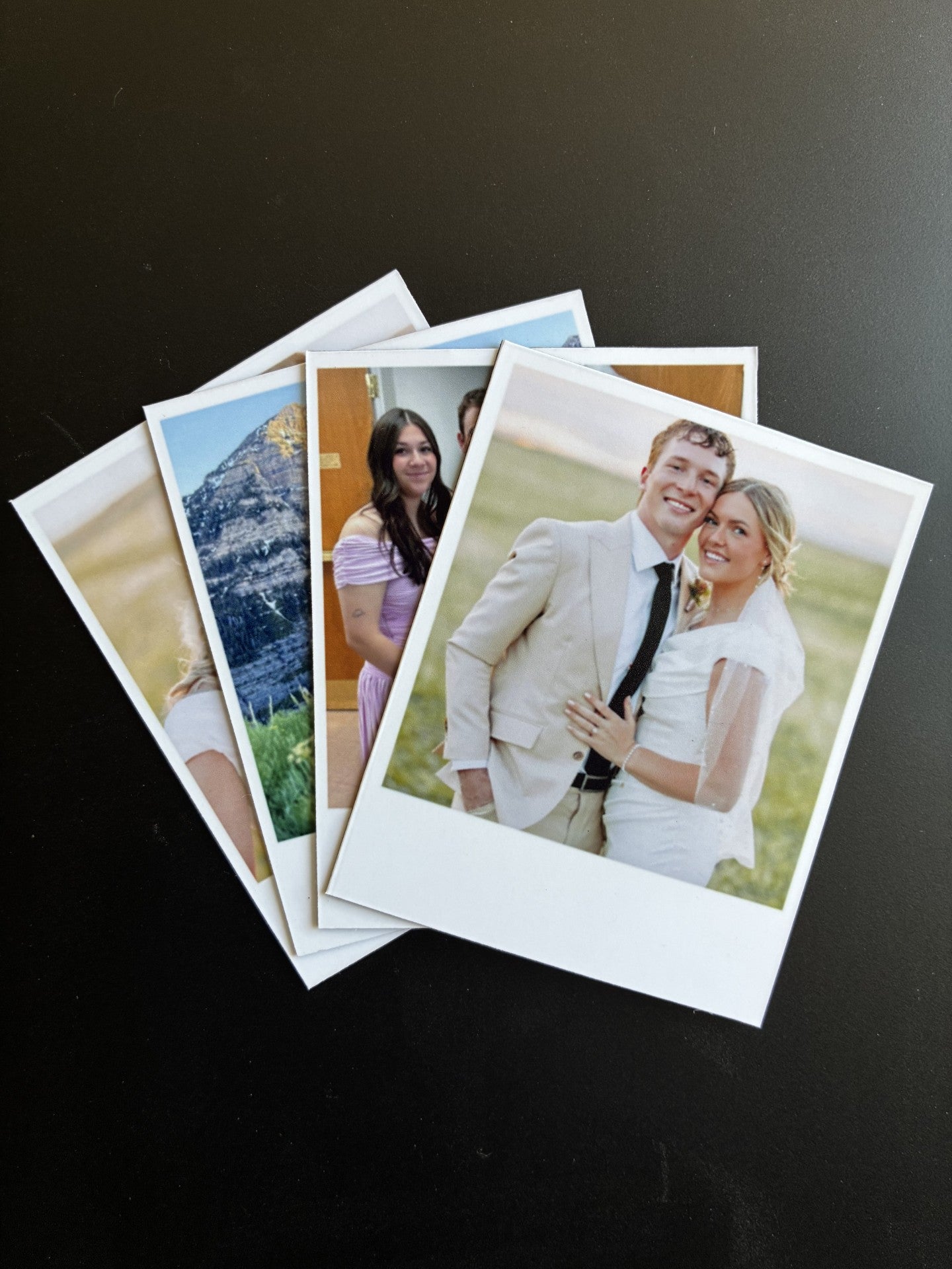 Set of Polaroid-style photos on a dark surface