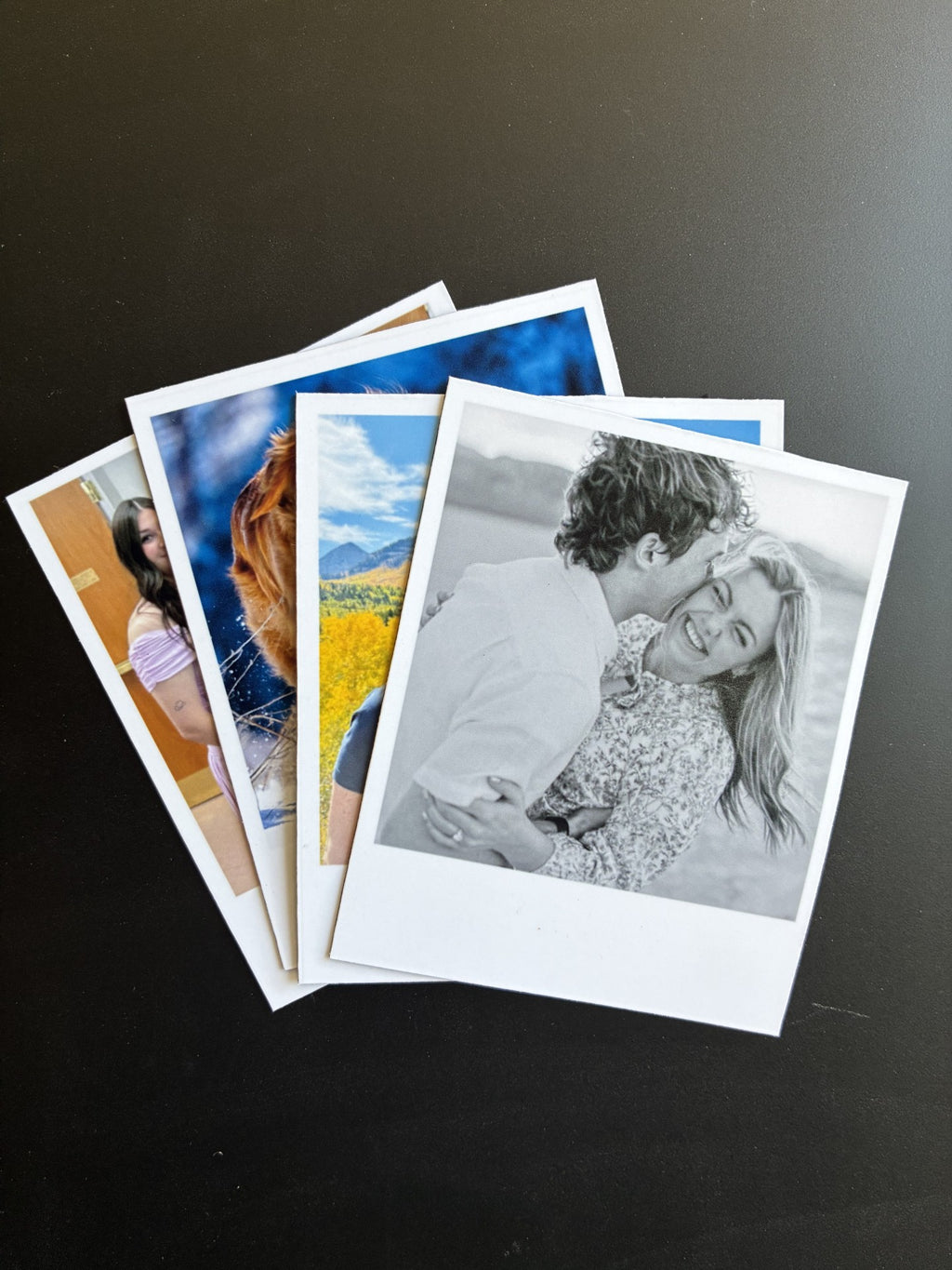 Collection of photo prints on a dark surface