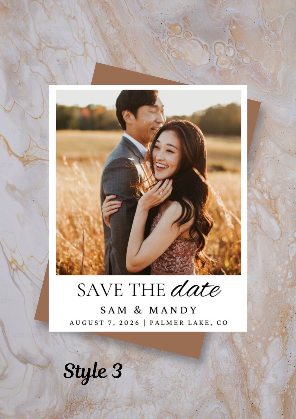 Wedding save the date magnet with a couple in a field on a marble background.